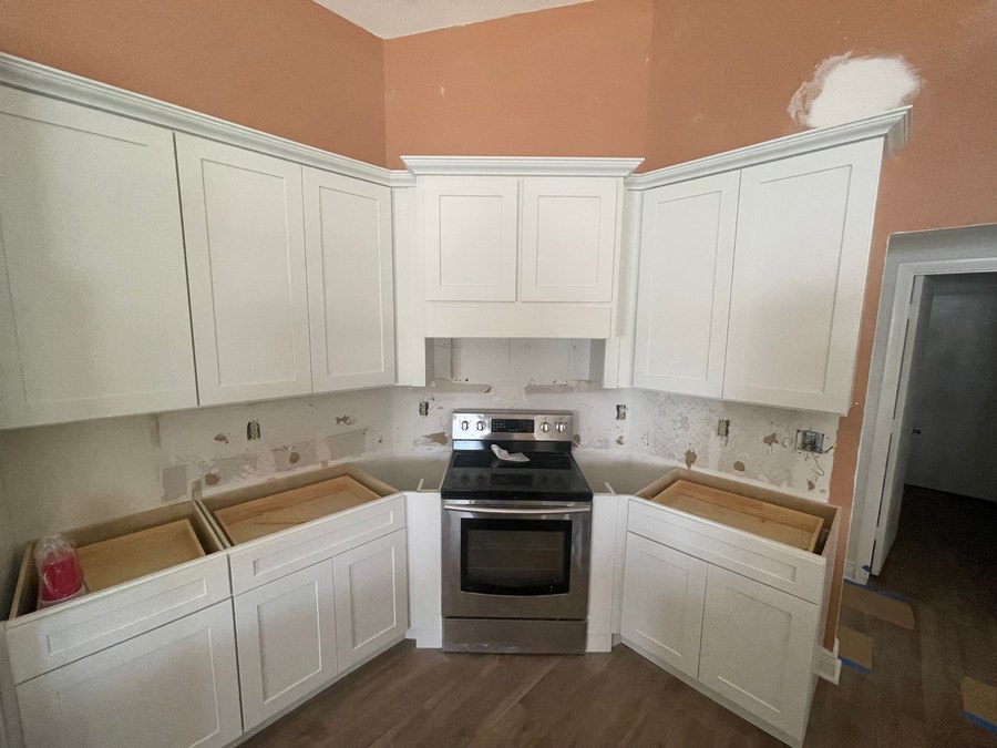 The same kitchen during the remodel, with the cabinets already installed before countertops and backsplash